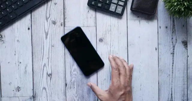 Detoks cyfrowy - telefon ekranem w dół na biurku obok notesu